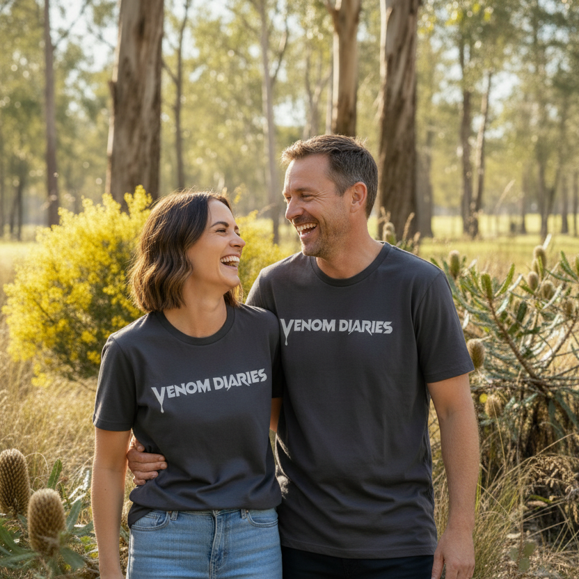 Two people wearing 'Venom Diaries' t-shirts standing in a forested area.
