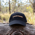 Venom Diaries cap front on log